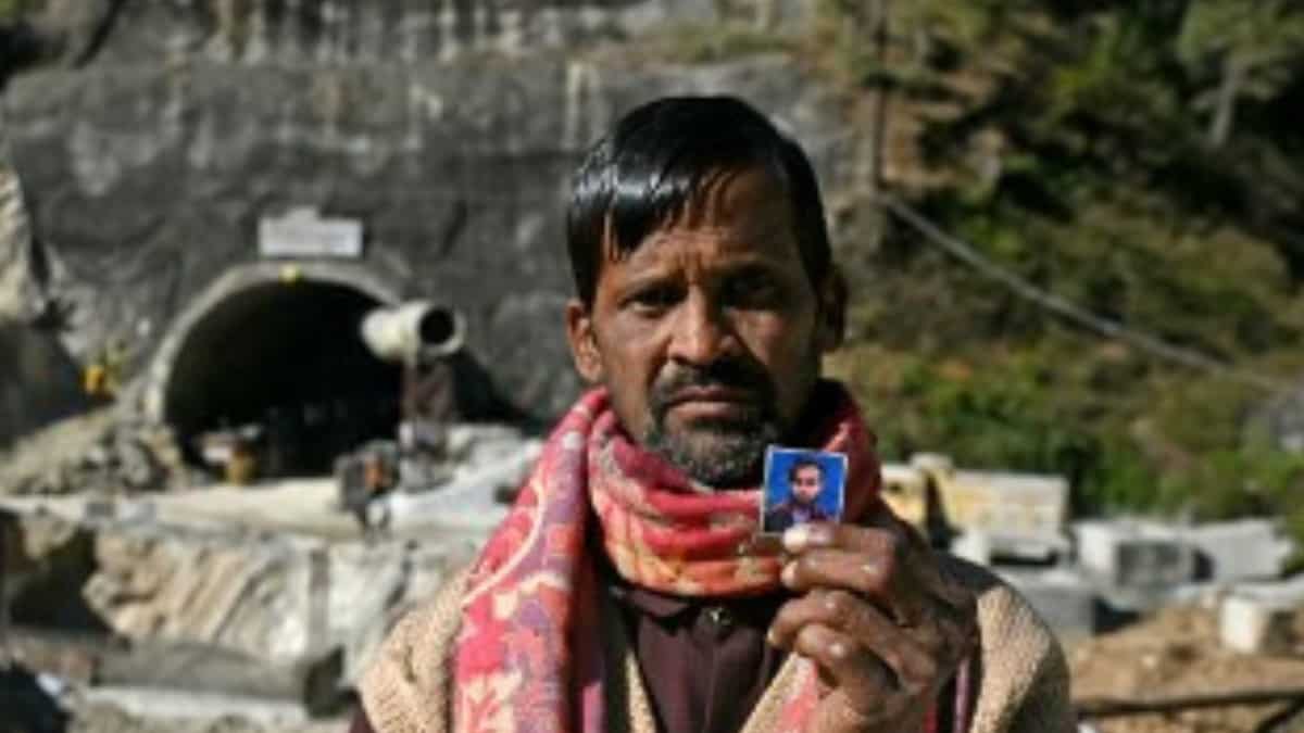 Choudhary, shows a picture of his son Manjeet Kumar on Nov 21, 2023. The two were reunited on the night on Nov 22, 2023 | AFP